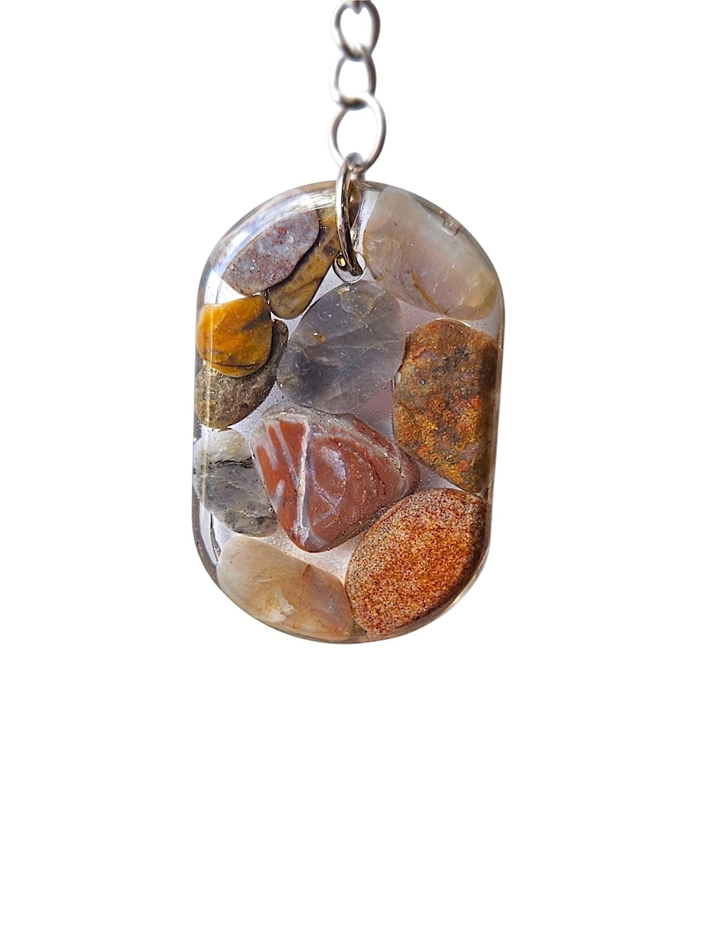 Nature's Stash handmade oval resin keyring featuring embedded polished natural gemstones and petrified wood fragments.