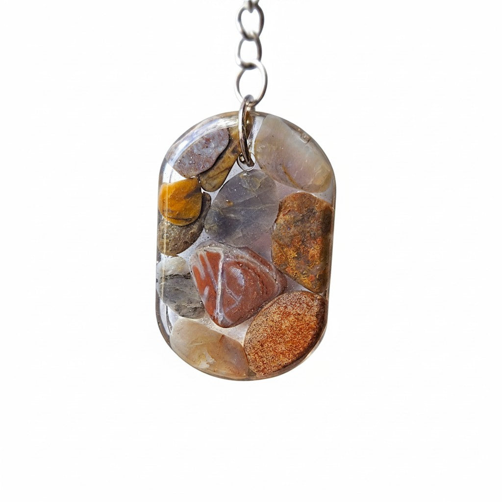 Nature's Stash handmade oval resin keyring featuring polished natural gemstones and petrified wood in earthy tones.