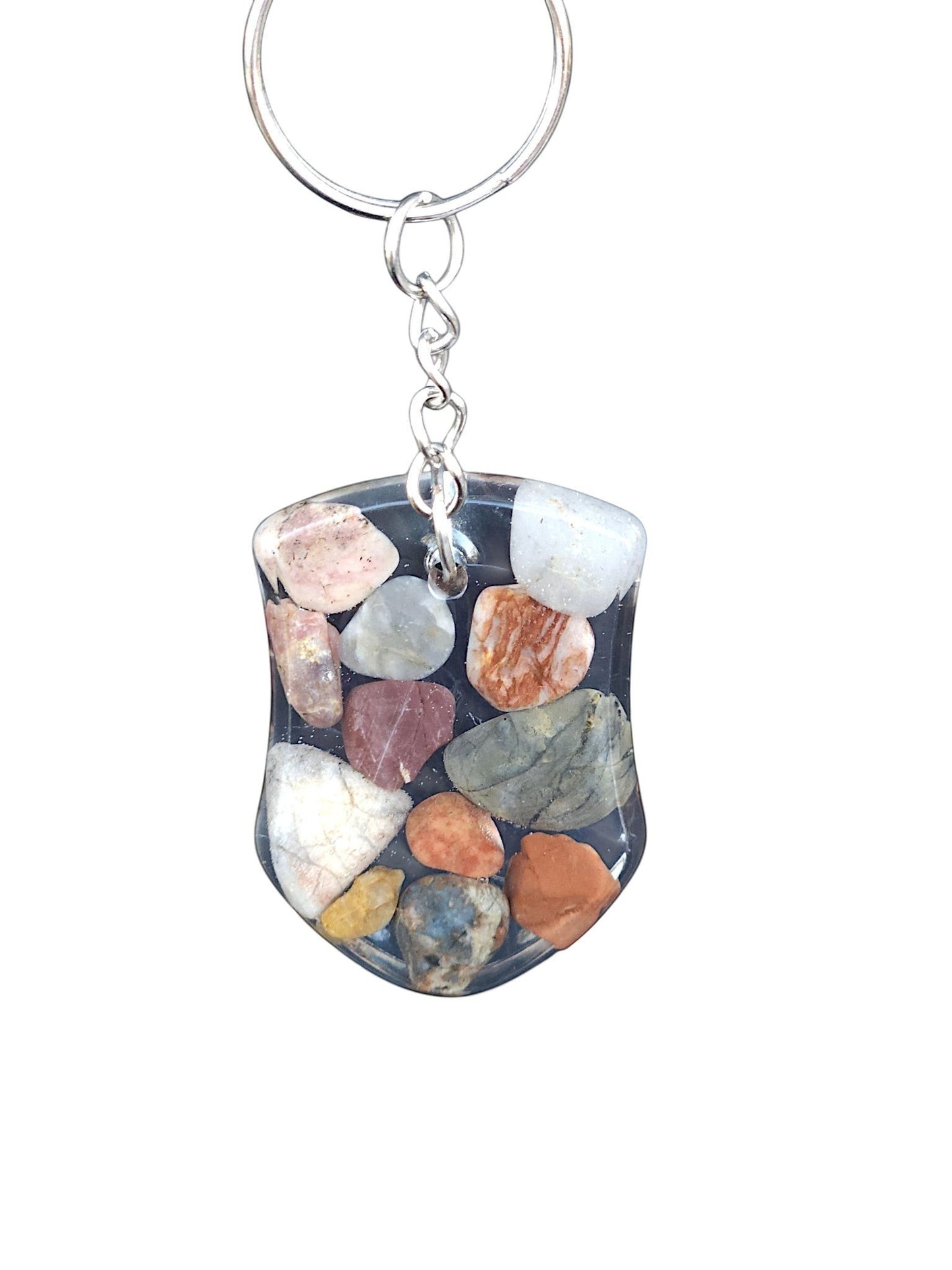 Nature's Stash handmade shield-shaped resin keyring featuring embedded polished multi-coloured natural gemstones.
